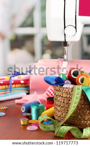 sewing machine and fabric on bright background