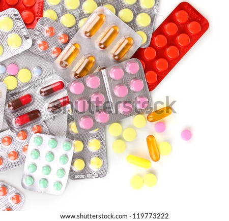 Capsules and pills packed in blisters isolated on white close-up