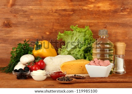 Ingredients for pizza on brown background
