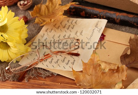 autumn background:romantic letter, glasses and leaves