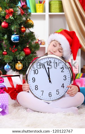 Beautiful little girl sleep in anticipation of New Year in festively decorated room