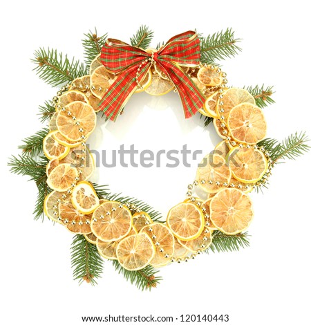 christmas wreath of dried lemons with fir tree and bow isolated on white