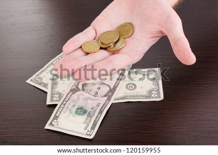 Counting money in hand on wooden table background