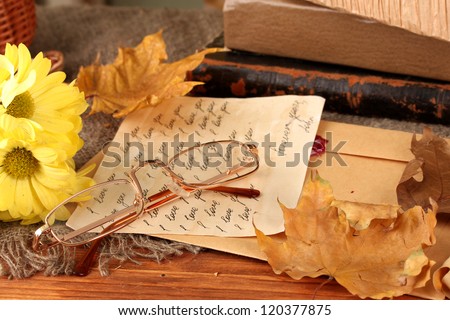 autumn background:romantic letter, glasses and leaves