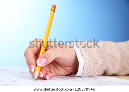 Closeup of businesswoman hands, writing on paper
