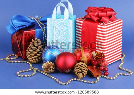 New Year composition of New Year\'s decor and gifts on blue background
