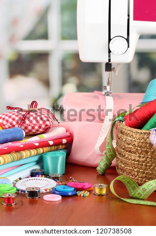 sewing machine and fabric on bright background