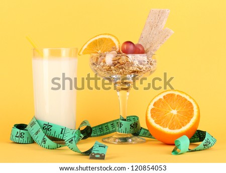 Lungs muesli in vase for desserts with glass milk on yellow background