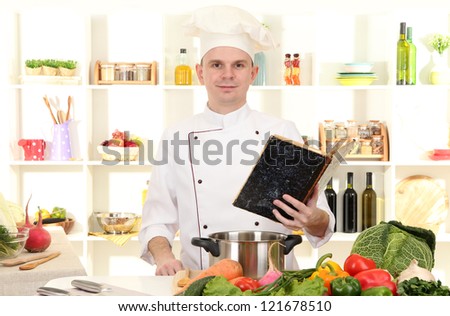 Chef thinking with book recipe in cuisine
