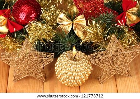 Christmas composition  with candles and decorations in red and gold colors on wooden background