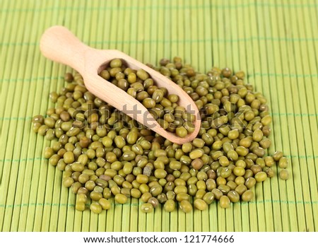 mung beans with scoop on color background