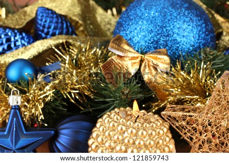 Christmas composition  with candles and decorations in  blue and gold colors on wooden background