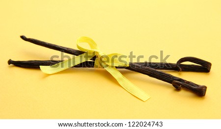 Vanilla pods on yellow background