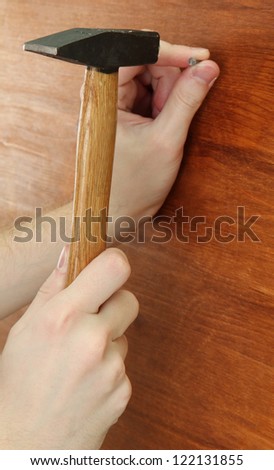 man hands with nail and hammer