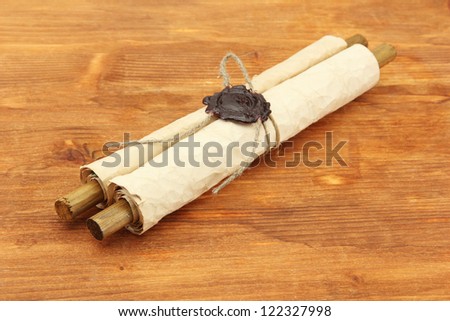 Old scroll, on wooden background