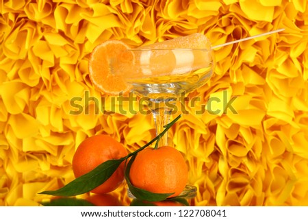 Yellow fruit juice ice in vase on decorative yellow background