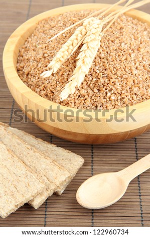 Wooden bowl full of wheat bran