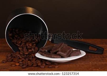 Coffee maker with chocolate on wooden table