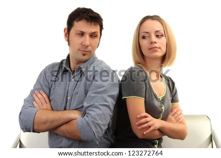 Young couple turning away from each other isolated on white