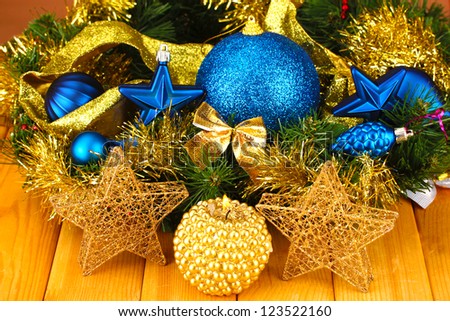Christmas composition  with candles and decorations in  blue and gold colors on wooden background