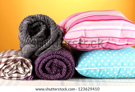 Plaids and color pillows on yellow background