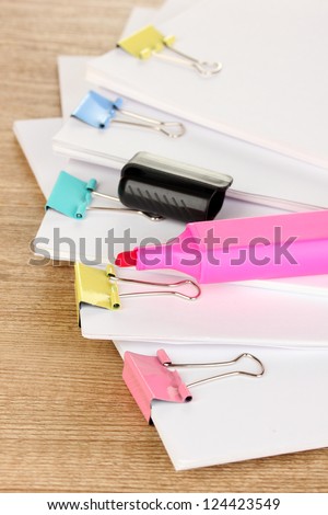 Documents with binder clips on wooden table