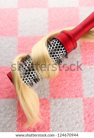 comb brush with hair on pink  tile wall background
