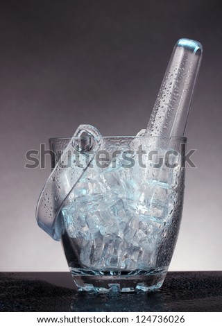 Glass ice bucket on grey  background