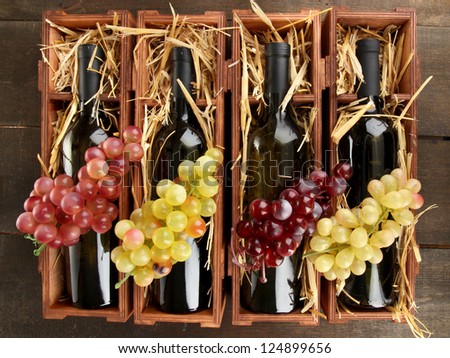 Wooden case with wine bottles on wooden table