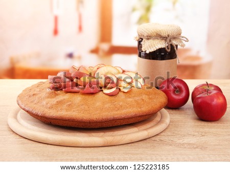 tasty homemade pie with apples and jam, on wooden table in cafe