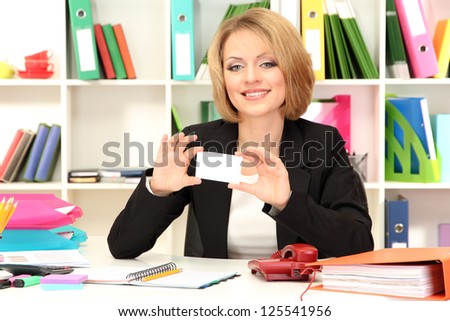 Young beautiful business woman in office at her workplace