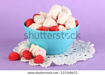 Gentle marshmallow in bowl on purple background