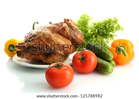Tasty whole roasted chicken on plate with vegetables, isolated on white