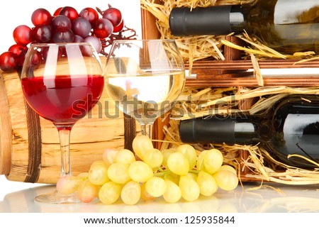 Wooden case with wine bottle, barrel, wineglasses and grape close up