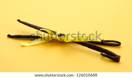 Vanilla pods on yellow background
