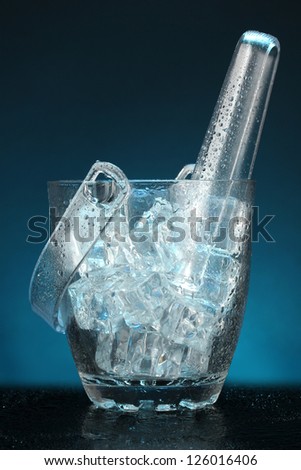 Glass ice bucket on dark blue background
