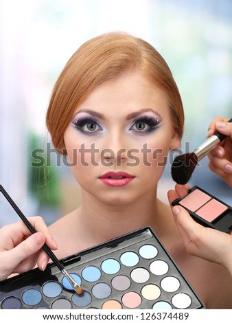 Portrait of beautiful young woman with making makeup in beauty salon
