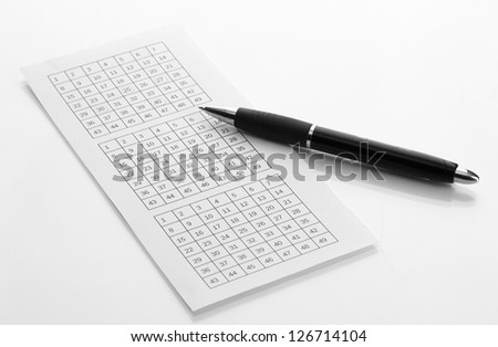 Lottery ticket and pen, isolated on white