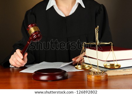Judge sitting at table during court hearings on black background