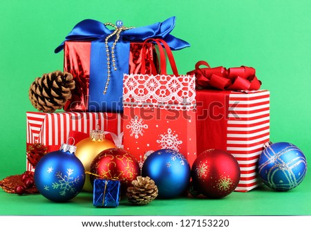 New Year composition of New Year\'s decor and gifts on green background