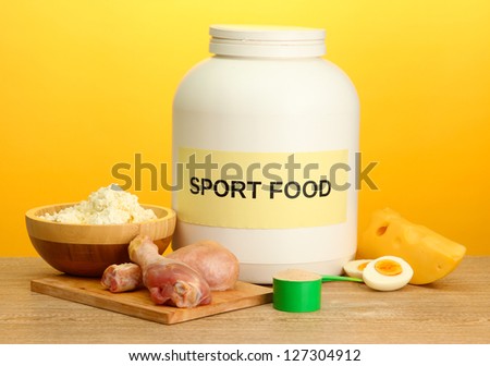 jar of protein powder and food with protein, on yellow background
