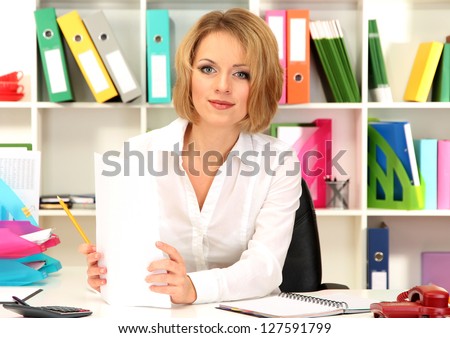Beautiful young business woman working in office