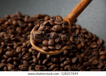 Black wok pan with coffee beans, close up