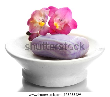 Soap-dish with soap and flower isolated on white
