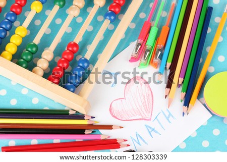 Toy abacus, note paper, pencils on bright background