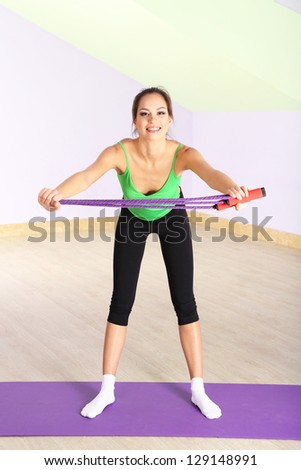 Young woman with skipping rope at gym