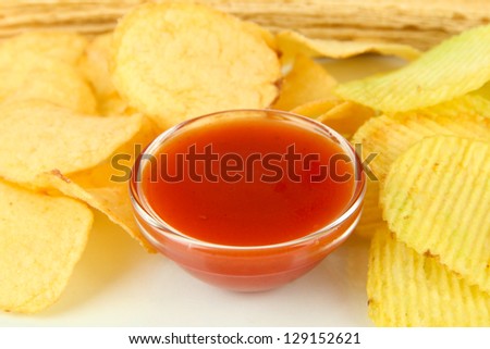 Potato chips and sauce, isolated on white