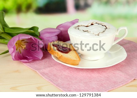 Composition of coffee, toast and tulips on bright background