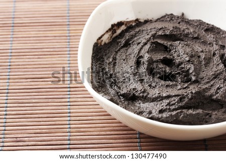 Cosmetic clay for spa treatments, on bamboo background