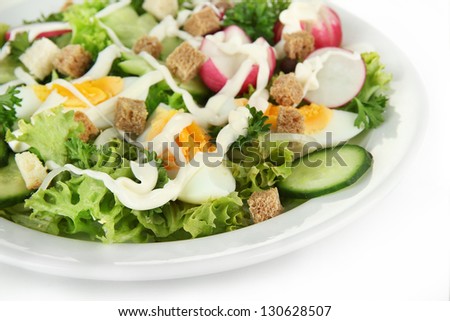 Fresh mixed salad with eggs, salad leaves and other vegetables, isolated on white